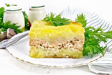 Image showing Casserole with potatoes and fish in plate on wooden board