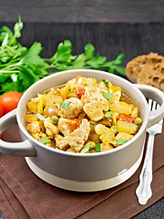 Image showing Chicken with vegetables and peas in saucepan on black board