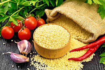 Image showing Couscous raw in bowl on dark board