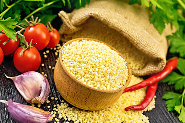 Image showing Couscous raw in bowl on wooden board