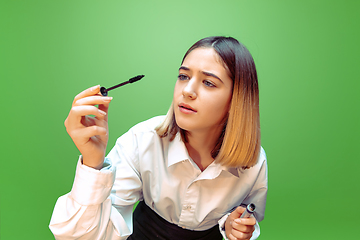 Image showing Little girl dreaming about future profession of makeup and hairstyle artist