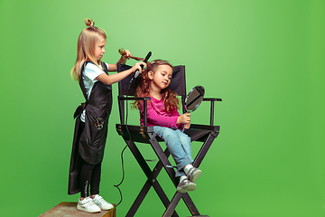 Image showing Little girl dreaming about future profession of visage and hairstyle artist