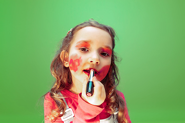 Image showing Little girl dreaming about future profession of makeup and hairstyle artist