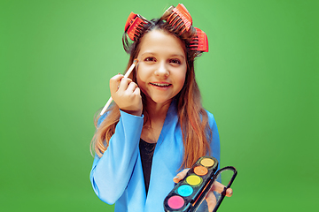 Image showing Little girl dreaming about future profession of makeup and hairstyle artist