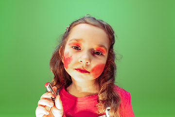 Image showing Little girl dreaming about future profession of makeup and hairstyle artist