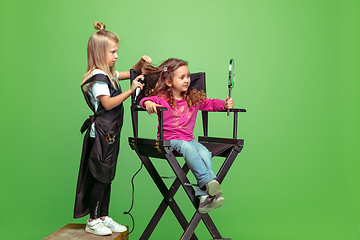 Image showing Little girl dreaming about future profession of visage and hairstyle artist