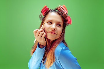 Image showing Little girl dreaming about future profession of makeup and hairstyle artist