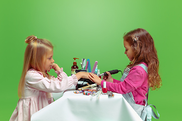 Image showing Little girl dreaming about future profession of nails manicure artist