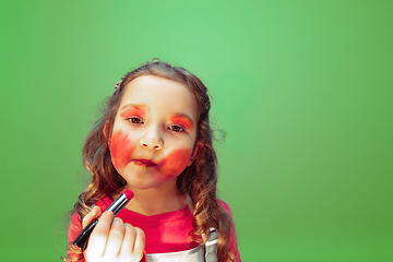 Image showing Little girl dreaming about future profession of makeup and hairstyle artist