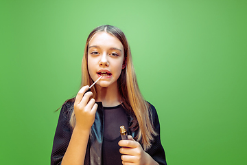 Image showing Little girl dreaming about future profession of makeup and hairstyle artist