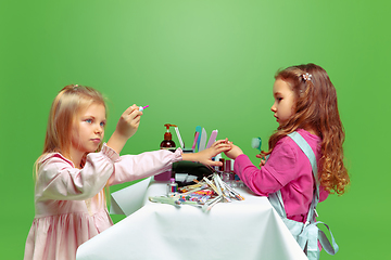 Image showing Little girl dreaming about future profession of nails manicure artist