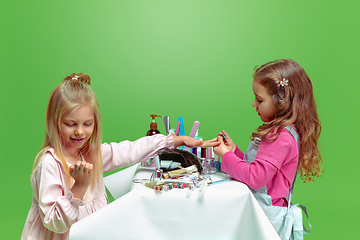 Image showing Little girl dreaming about future profession of nails manicure artist