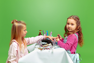 Image showing Little girl dreaming about future profession of nails manicure artist