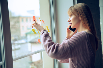 Image showing Beautiful caucasian business lady working in office, open-space