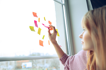 Image showing Beautiful caucasian business lady working in office, open-space