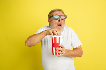 Image showing Caucasian senior man\'s portrait isolated on yellow studio background