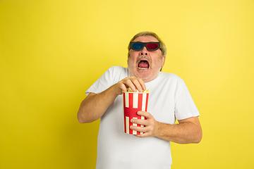 Image showing Caucasian senior man\'s portrait isolated on yellow studio background