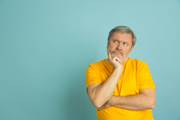 Image showing Caucasian senior man\'s portrait isolated on blue studio background