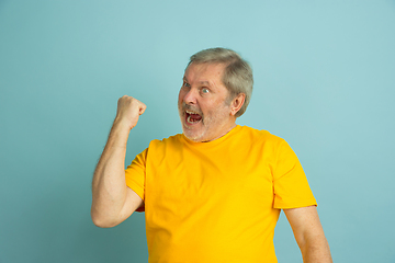 Image showing Caucasian senior man\'s portrait isolated on blue studio background