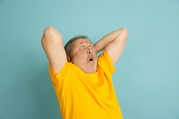 Image showing Caucasian senior man\'s portrait isolated on blue studio background