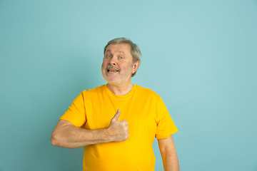 Image showing Caucasian senior man\'s portrait isolated on blue studio background