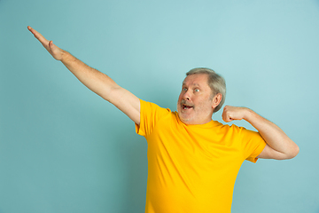 Image showing Caucasian senior man\'s portrait isolated on blue studio background