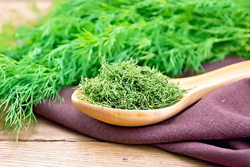 Image showing Dill dry in spoon on wooden board