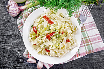 Image showing Fettuccine with zucchini and hot peppers in plate on board top