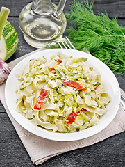 Image showing Fettuccine with zucchini and hot peppers in plate on towel
