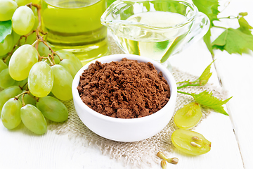 Image showing Flour grape seed in bowl on board