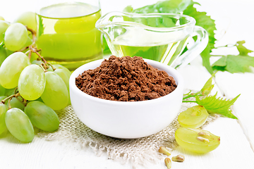 Image showing Flour grape seed in bowl on light wooden board