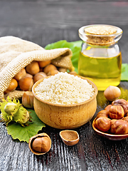 Image showing Flour in bowl with nuts on wooden board