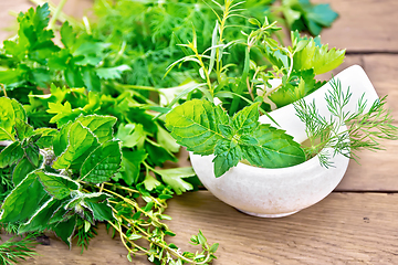 Image showing Herbs spicy in stone mortar on board