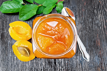 Image showing Jam apricot in jar on board top