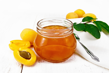 Image showing Jam apricot in jar on white board