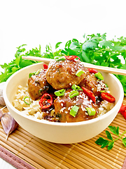 Image showing Meatballs in sweet and sour sauce with rice on board