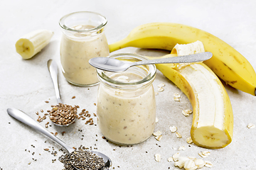 Image showing Milkshake with chia and banana in jars on granite table