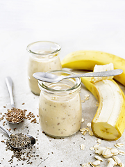 Image showing Milkshake with chia and banana in jars on stone table