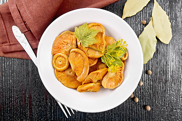 Image showing Mushrooms salted in plate on board top