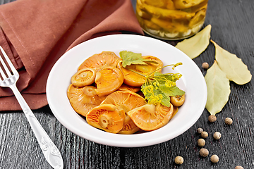 Image showing Mushrooms salted in plate on dark board