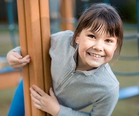 Image showing Cute little girl is playing in playground