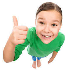 Image showing Little girl is showing thumb up gesture