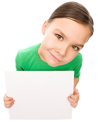Image showing Happy little girl is holding blank board