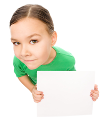 Image showing Happy little girl is holding blank board