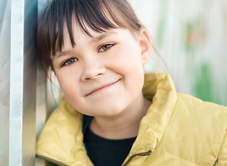 Image showing Portrait of a girl leaning to the wall