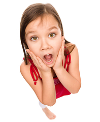 Image showing Little girl is holding her face in astonishment