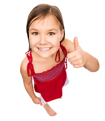 Image showing Little girl is showing thumb up gesture