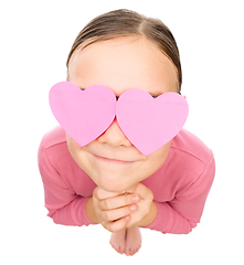 Image showing Little girl with hearts over her eyes