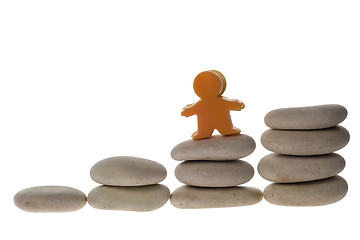 Image showing Figurine on stack of pebbles