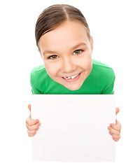 Image showing Happy little girl is holding blank board